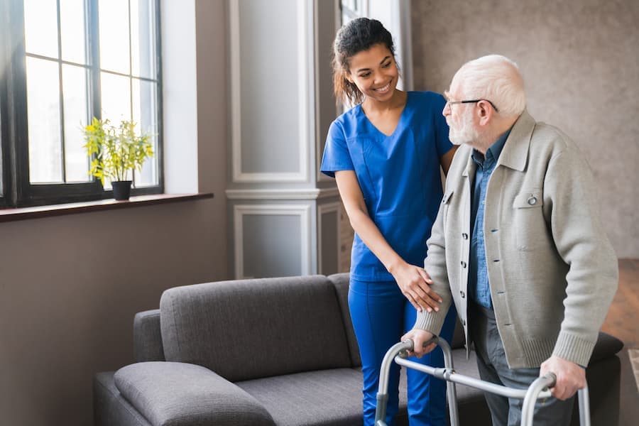Wise Medical caregiver assisting a client at home
